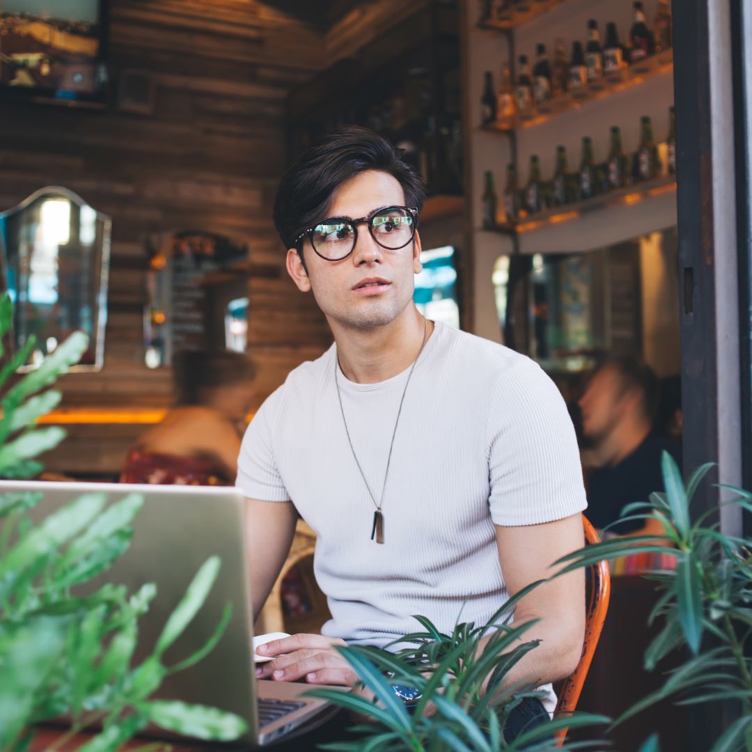 man in white t-shirt with plants 